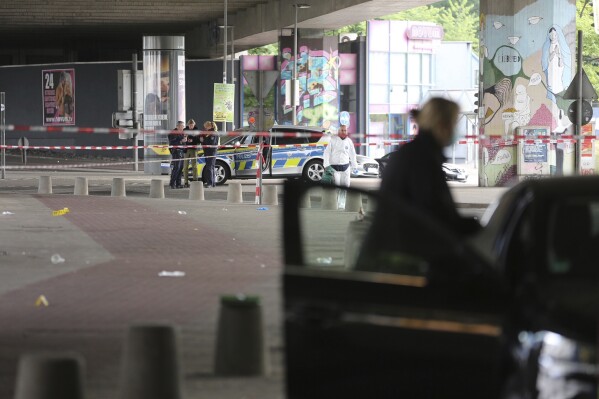 Police and forensic investigators are on the scene following an attack in the western city of Bielefeld, Germany, Sunday May 18, 2025. (Christian M'ller/dpa via AP)