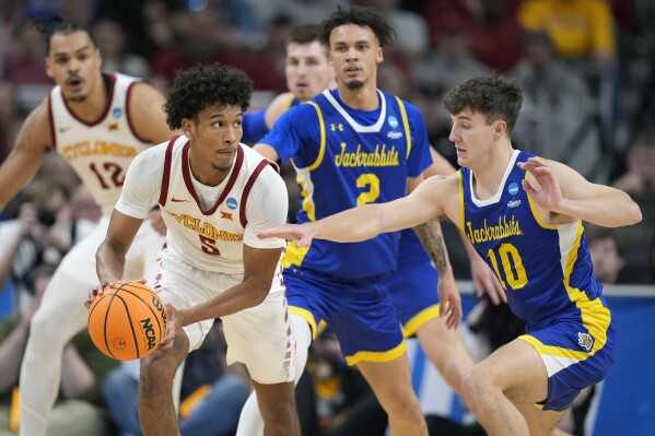 Iowa State's Curtis Jones (5) looks to pass as South Dakota State's Kalen Garry (10) defends during the first half of a first-round college basketball game in the NCAA Tournament Thursday, March 21, 2024, in Omaha, Neb. (AP Photo/Charlie Neibergall)