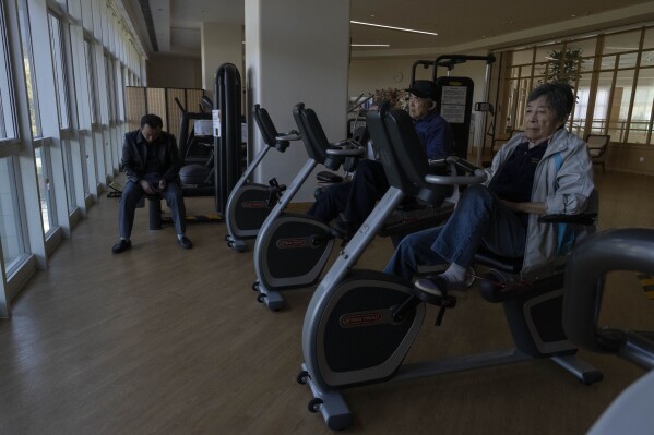 Residents work out in the exercise room at Yan Garden, a high-end senior-focused community that opened in 2015 by insurance company Taikang Insurance Group in Beijing, Nov. 5, 2024. (AP Photo/Ng Han Guan)