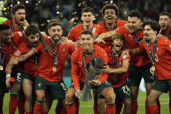 Portugal's Cristiano Ronaldo celebrates with teammates after winning the Nations League final soccer match between Portugal and Spain at the Allianz Arena in Munich, Germany, Monday, June 9, 2025. (AP Photo/Matthias Schrader)