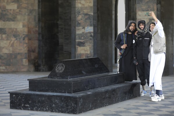 Taliban fighters take selfies by the tomb of Afghan Kind Nadir Shah in Kabul, Afghanistan, Wednesday, April 24, 2024. (AP Photo/Siddiqullah Alizai)