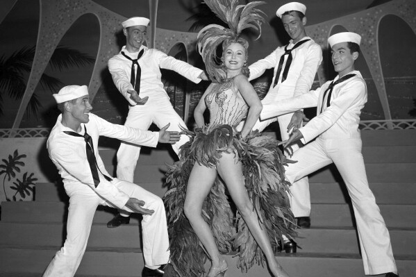 FILE - In this May 20, 1957 file photo, Actress Rhonda Fleming blossoms out as a singer and dancer in the first night club appearance of her career at the New Tropicana hotel in Las Vegas. When the Tropicana Las Vegas opened in 1957, Nevada's lieutenant governor at the time turned the key to open the door on what would become a Sin City landmark for more than six decades. Then he threw away the key. “This was to signify that the Tropicana would always stay open,” said historian Michael Green. Six decades later, the storied hotel-casino that once had ties to the mob and had been nicknamed the “Tiffany of the Strip,” is set to shut its doors for good to make room for a $1.5 billion Major League Baseball stadium. (AP Photo/David Smith, File)