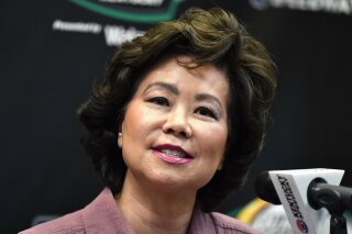 FILE - In this July 13, 2019, file photo, Transportation Secretary Elaine Chao addresses the media before the NASCAR series auto race at Kentucky Speedway in Sparta, Ky. The House Oversight Committee says it is investigating whether Chao acted improperly to benefit herself or her family’s shipping company. (AP Photo/Timothy D. Easley, File)