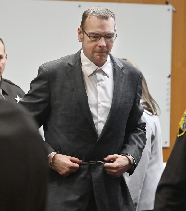 James Crumbley, leaves the courtroom during a break in his trial for involuntary manslaughter at the Oakland County Courtroom on March 11, 2024, in Pontiac, Mich. He is accused of failing to secure a gun at home and ignoring signs of his son Ethan Crumbley's mental distress. (Daniel Mears/Detroit News via AP, Pool)