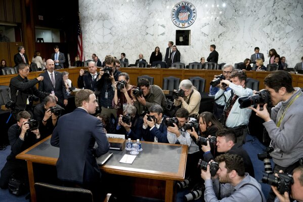 FILE - In this April 10, 2018, file photo, Facebook CEO Mark Zuckerberg returns from a break as he testifies before a joint hearing of the Commerce and Judiciary Committees on Capitol Hill in Washington. The U.S. Justice Department and the Federal Trade Commission are moving to investigate Google, Facebook, Amazon and Apple over their aggressive business practices, and the House Judiciary Committee has announced an antitrust probe of unidentified technology companies. (AP Photo/Andrew Harnik, File)