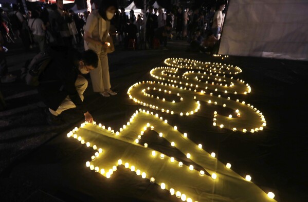 Participants attend a candlelight vigil at Democracy Square to mark the 36th anniversary of the Chinese military crackdown on the pro-democracy movement in Beijing's Tiananmen Square, in Taipei, Taiwan, Wednesday, June 4, 2025. (AP Photo/Chiang Ying-ying)
