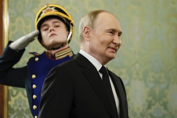 Russian President Vladimir Putin arrives to meet with Bahrain's Crown Prince and Prime Minister Salman bin Hamad bin Isa Al Khalifa prior to their talks at the Kremlin in Moscow, Russia, Thursday, May 23, 2024. (Yury Kochetkov/Pool Photo via AP)