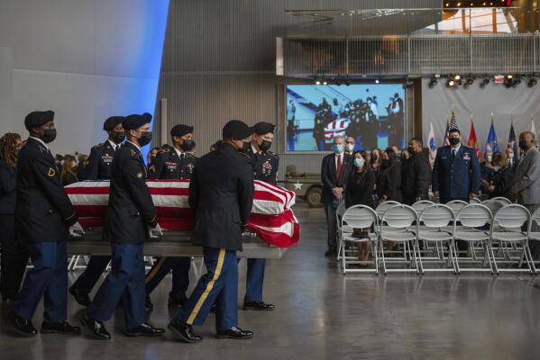 The casket of Lawrence Brooks, who had been the oldest living World War II Veteran, is carried at a memorial service at The National World War II Museum in New Orleans, Saturday, Jan. 15, 2022. Brooks, who died Jan. 5, was 112. (AP Photo/Kathleen Flynn)