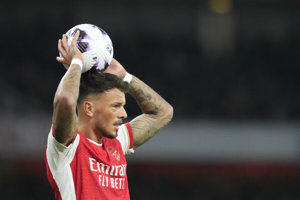 Arsenal's Ben White throws the ball during the English Premier League soccer match between Arsenal and Brentford at the Emirates Stadium in London, England, Saturday, March 9, 2024. (AP Photo/Frank Augstein)