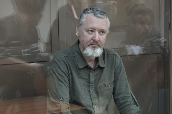 Igor Girkin also know as Igor Strelkov, the former military chief for Russia-backed separatists in eastern Ukraine, sits in a glass cage in a courtroom at the Moscow's City Court in Moscow, Russia, on Tuesday, Aug. 29, 2023. A prominent Russian hard-line nationalist who accused President Vladimir Putin of weakness and indecision in Ukraine was detained on charges of extremism. (AP Photo/Alexander Zemlianichenko)