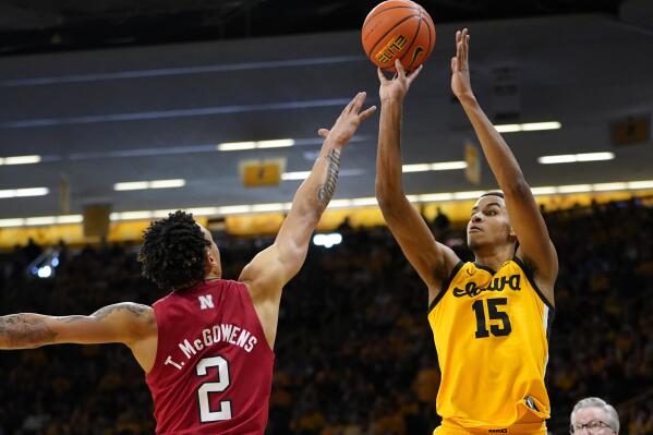Iowa forward Keegan Murray (15) shoots over Nebraska guard Trey McGowens (2) during the second half of an NCAA college basketball game, Sunday, Feb. 13, 2022, in Iowa City, Iowa. Iowa won 98-75. (AP Photo/Charlie Neibergall)