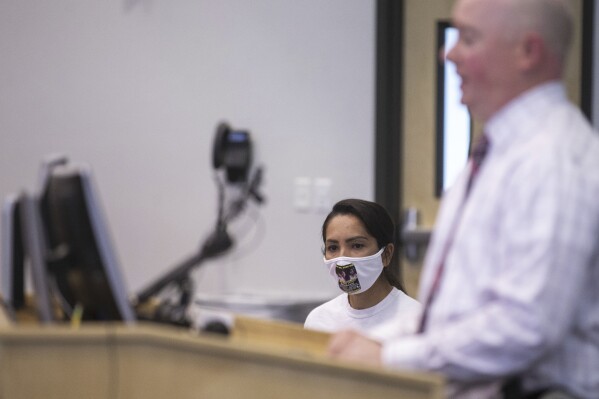 Jessica Nunez, the mother of a girl who went missing days before her 15th birthday in 2019, listens as Glendale police Sgt. Patrick Beaumler speaks during a press conference on the first anniversary of her daughter's disappearance on Sept. 15, 2020, at Glendale Regional Public Safety Training Center in Glendale, Ariz. Authorities announced Wednesday, July 26, 2023, that Nunez's daughter walked into a small-town police station in Montana this week. (The Arizona Republic via AP)