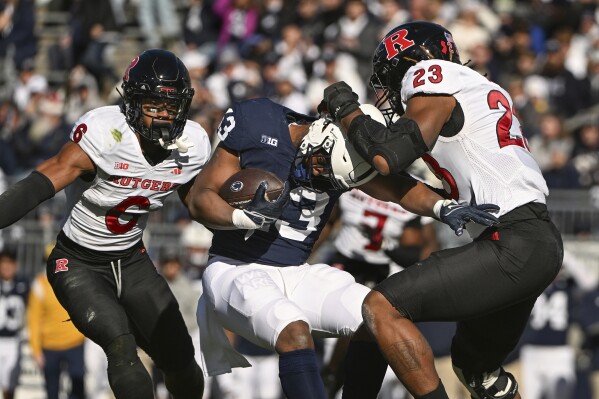 Rutgers defensive lineman Wesley Bailey (23) tackles Penn State running back Kaytron Allen (13) during the first half of an NCAA college football game, Saturday, Nov. 18, 2023, in State College, Pa. (AP Photo/Barry Reeger)