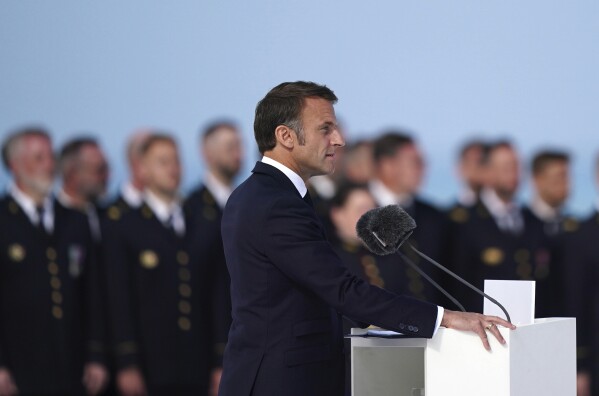 President of France Emmanuel Macron speaks during the official international ceremony to mark the 80th anniversary of D-Day, at Omaha Beach in Saint-Laurent-sur-Mer, Normandy, France, Thursday, June 6, 2024. (Jordan Pettitt/Pool Photo via AP)