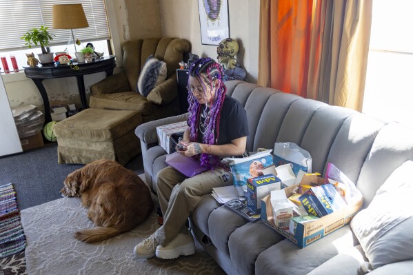 Kimra Luna, packs abortion aftercare kits which will be mailed to Nebraska, S. Dakota and Idaho at their home in Nampa, Idaho, on Friday, April 12, 2024. “We’ve always found a way to make sure people get help no matter what that help is,” Luna said of their group. (AP Photo/Kyle Green)