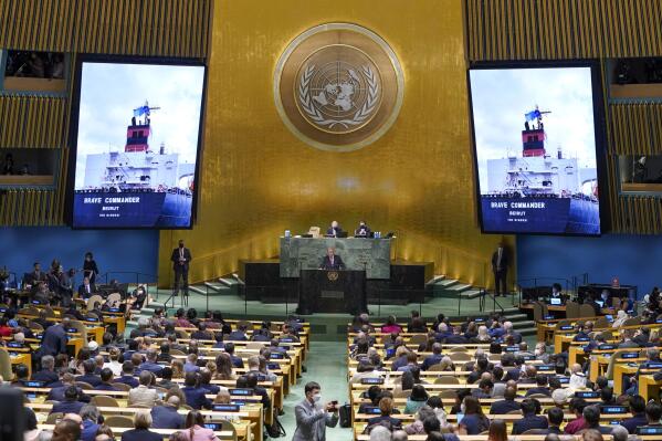 An image of the 'Brave Commander' ship carrying grain from Ukraine is displayed on screens as Secretary-General António Guterres addresses the 77th session of the General Assembly at United Nations headquarters Tuesday, Sept. 20, 2022. (AP Photo/Mary Altaffer)