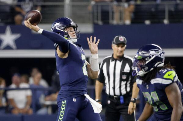 Dallas Cowboys' Nahshon Wright (25) defends as safety Markquese Bell (41)  gains yards after intercdepting a Seattle Seahawks pass in the second half  of a preseason NFL football game in Arlington, Texas