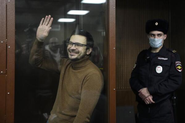Russian opposition activist and former municipal deputy of the Krasnoselsky district Ilya Yashin stands in a cage in a courtroom prior to a hearing in Moscow, Russia, Tuesday, Nov. 29, 2022. Yashin, one of the few prominent opposition figures to have remained in the country amid an intensifying crackdown on dissent was arrested in June in a Moscow park and later was charged with spreading false information about the Russian military — a new criminal offense for which he faces up to 10 years in prison if convicted. (AP Photo/Alexander Zemlianichenko)