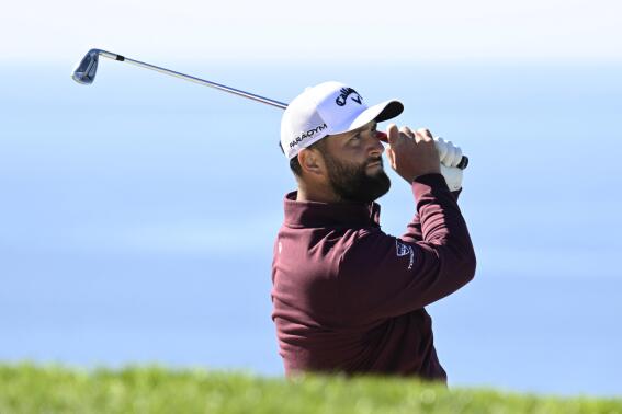 Jon Rahm, of Spain, watches his shot from a bunker on the fifth hole of the South Course at Torrey Pines during the first round of the Farmers Insurance Open golf tournament Wednesday, Jan. 25, 2023, in San Diego. (AP Photo/Denis Poroy)