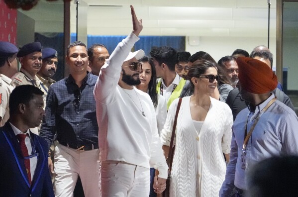 Bollywood actors Ranveer Singh, left and Deepika Padukone arrive at airport to attend the pre-wedding celebrations of Anant Ambani and Radhika Merchant in Jamnagar, India, Thursday, Feb. 29, 2024. (AP Photo/Ajit Solanki)