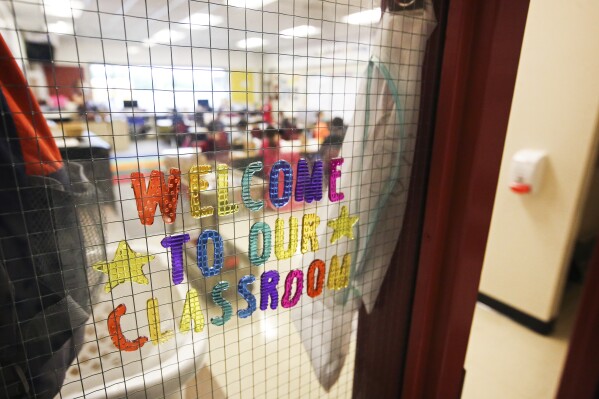 FILE - Students eat breakfast and color in Topaz Stotts' second-grade classroom before school starts at Klatt Elementary School in Anchorage, Aug. 17, 2021. Debate over school funding is dominating the Alaska Legislature as districts face teacher shortages and in some cases multimillion-dollar deficits. Schools have cut programs, increased class sizes or had teachers and administrators take on extra roles. (Emily Mesner/Anchorage Daily News via AP, File)