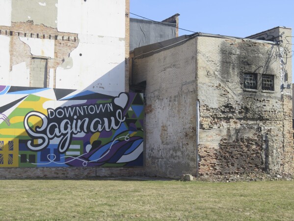 Afternoon sunshine hits parts of a mural in downtown Saginaw, Mich., Wednesday, March 12. The city's downtown has undergone mass transformation in the decades since it was one of the state's top automotive hubs. (AP Photo/Joey Cappelletti)