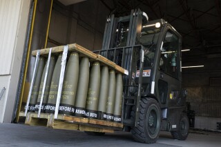 FILE - Airmen with the 436th Aerial Port Squadron use a forklift to move 155 mm shells ultimately bound for Ukraine, April 29, 2022, at Dover Air Force Base, Del. The Pentagon will provide Ukraine with another $200 million in weapons and ammunition to help sustain its counteroffensive as troops on the front lines face significant hurdles against a well-entrenched Russian defense. (AP Photo/Alex Brandon, File)