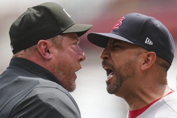 St. Louis Cardinals manager Oliver Marmol, right, reacts after being ejected by umpire Bruce Dreckman during the eighth inning of the first baseball game of a doubleheader against the Cincinnati Reds, Wednesday, April 30, 2025, in Cincinnati. (AP Photo/Jeff Dean)