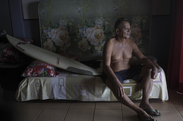Teahupo'o native Gregory Parker poses for a portrait in the beachfront bungalow that he will rent out to Olympic accredited officials during the Olympic surf competition in Teahupo'o, Tahiti, French Polynesia, Sunday, Jan. 14, 2024. (AP Photo/Daniel Cole)