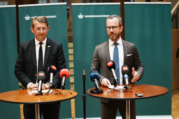 Jakob Ellemann-Jensen, right, and Troels Lund Poulsen attend a press conference in the Ministry of Defense in Copenhagen, Denmark, Tuesday Aug. 22, 2023. Jakob Ellemann-Jensen — the deputy prime minister in the Danish three-party coalition — said he will act as economy minister while Troels Lund Poulsen who acted as defense minister while Ellemann-Jensen was on a five-month leave of absence for health reasons, returned to the defense ministry. (Ida Marie Odgaard/Ritzau Scanpix via AP)