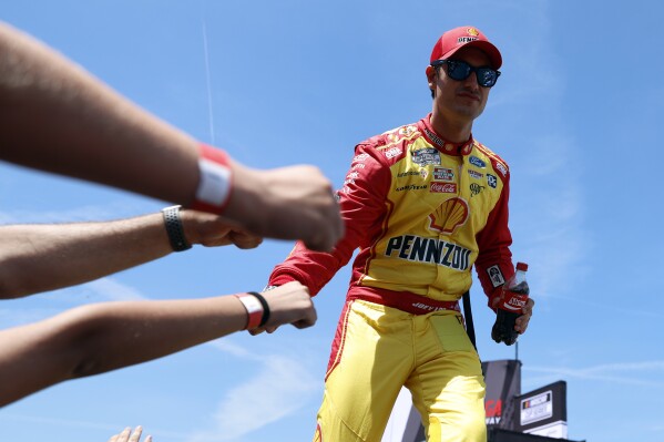 Driver Joey Logano greets fans before a NASCAR Cup Series auto race at Talladega Superspeedway, Sunday, April 27, 2025, in Talladega, Ala. (AP Photo/Butch Dill)