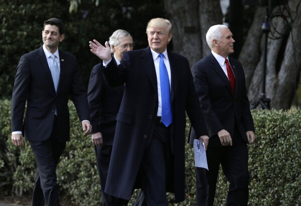 
              President Donald Trump walks with Vice President Mike Pence, House Speaker Paul Ryan, R-Wis., and Senate Majority Leader Mitch McConnell, R-Ky. during a bill passage event on the South Lawn of the White House in Washington, Wednesday, Dec. 20, 2017, to acknowledge the final passage of tax overhaul legislation by Congress. (AP Photo/Evan Vucci)
            