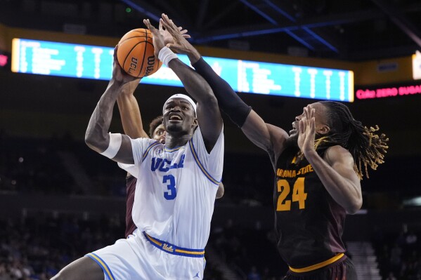 UCLA's Adem Bona (3) shoots against Arizona State forward Bryant Selebangue (24) during the second half of an NCAA college basketball game in Los Angeles, Saturday, March 9, 2024. UCLA won 59-47. (AP Photo/Jae C. Hong)