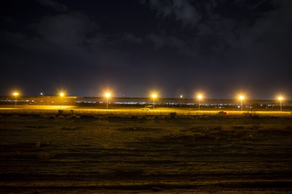 The border wall of El Paso, Texas, is seen from Ciudad Juarez, Mexico, early Friday, Aug. 9, 2024. (AP Photo/Andres Leighton)