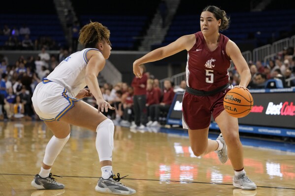 Washington State guard Charlisse Leger-Walker, right, drives against UCLA guard Kiki Rice, left, during the first half of an NCAA college basketball game, Sunday, Jan. 28, 2024, in Los Angeles. (AP Photo/Ryan Sun)