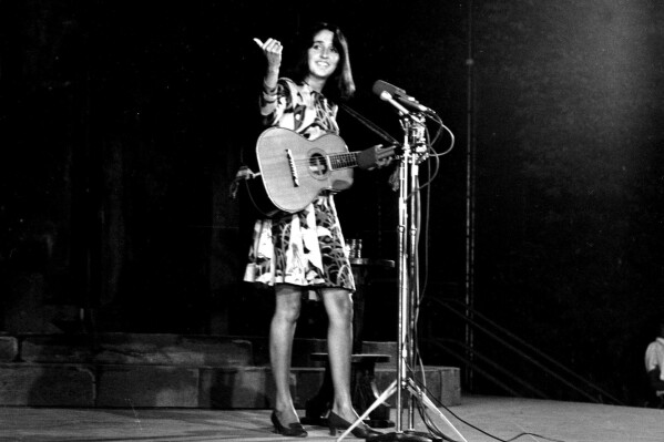 Folk singer Joan Baez performs at the Washington Monument in Washington, D.C. on Aug. 14, 1967. (AP Photo/ John Rous, File)