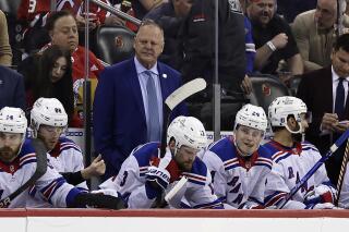 New York Rangers head coach Gerard Gallant, center top, looks on during the first period of Game 7 against the New Jersey Devils in an NHL hockey Stanley Cup first-round playoff series Monday, May 1, 2023, in Newark, N.J. (AP Photo/Adam Hunger)