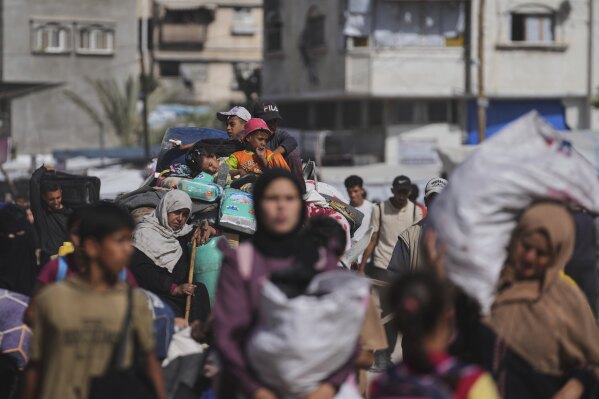 Displaced Palestinians flee from Khan Younis, Gaza, amid the ongoing Israeli military offensive in the area, on Monday, May 19, 2025. (AP Photo/Abdel Kareem Hana)
