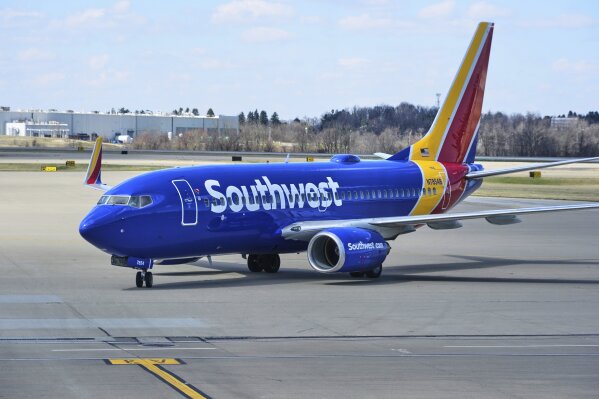 A Southwest Airlines plane pull into a gate at Pittsburgh International Airport in Imperial, Pa., Thursday, March 27, 2025. (AP Photo/Gene J. Puskar, File)
