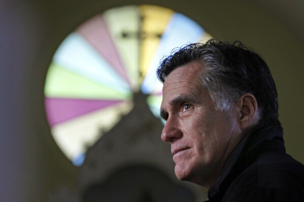 FILE - Republican presidential candidate, former Mass. Gov. Mitt Romney, visits St. Paul's Lutheran Church while campaigning in Berlin, N.H., Dec. 22, 2011. (AP Photo/Charles Krupa, File)