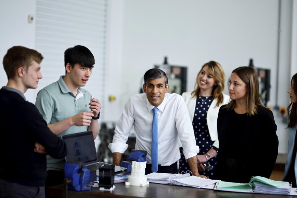 Britain's Prime Minister and Conservative Party leader Rishi Sunak speaks with students during a visit of University Technical College (UTC) in Silverstone, England, Tuesday June 11, 2024, in the build-up to the UK general election on July 4. (Benjamin Cremel, Pool Photo via AP)