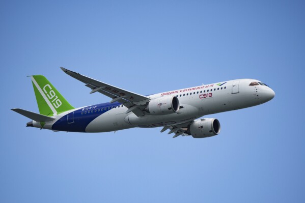 FILE - A China's Comac C919 aircraft performs during first day of Singapore Airshow in Singapore, Tuesday, Feb. 20, 2024. China鈥檚 C919 single-aisle jet made its international debut at the Singapore Airshow, attracting masses of visitors and hundreds of orders, but analysts say it still has a long way to go before it can compete with aircraft from market leaders Boeing and Airbus. (AP Photo/Vincent Thian, File)