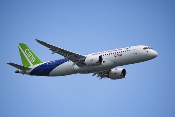 FILE - A China's Comac C919 aircraft performs during first day of Singapore Airshow in Singapore, Tuesday, Feb. 20, 2024. China’s C919 single-aisle jet made its international debut at the Singapore Airshow, attracting masses of visitors and hundreds of orders, but analysts say it still has a long way to go before it can compete with aircraft from market leaders Boeing and Airbus. (AP Photo/Vincent Thian, File)