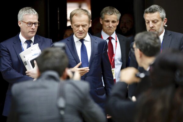 European Council President Donald Tusk, second left, arrives for a media conference at an EU summit in Brussels, Tuesday, July 2, 2019. After three days of arduous negotiations, European Union leaders broke their top job deadlock Tuesday and nominated German Defense Minister Ursula von der Leyen to become the new president of the bloc's powerful executive arm, the European Commission, taking over from Jean-Claude Juncker for the next five years. (AP Photo/Olivier Matthys)