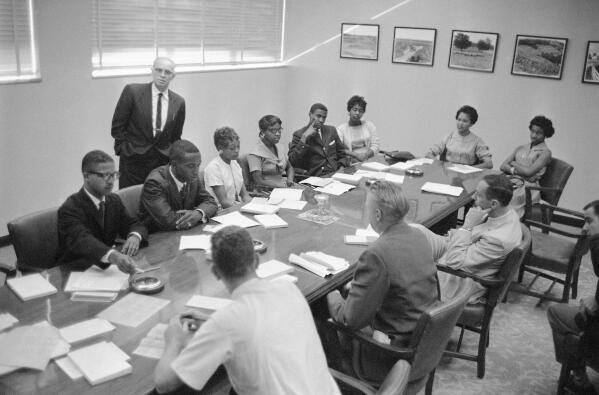 FILE - These eight African-Americans were the first in the history of Memphis State University to register for classes at the formally all white school in Memphis, Tenn., Sept. 10, 1959. At a press conference during registration are from left, Ralph Prater, Luther McClellan, Joyce Gandy, Bertha Rogers, John Simpson, Rosie Blakney, Sammie Burnett and Marvis Kneeland. Dean R.M. Robison is in background. Prater, one of the first Black students to enroll at then-Memphis State University in 1959, died on Sunday, Aug. 7, 2022. He was 81. (AP Photo/Perry Aycock, File)