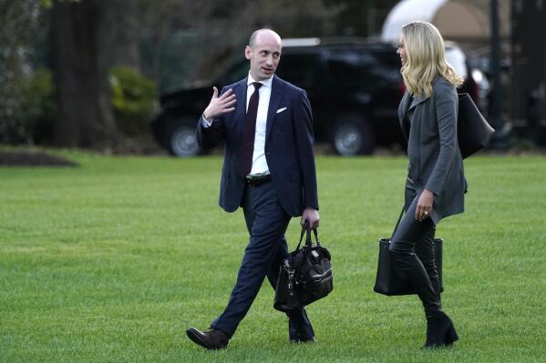 FILE - White House press secretary Kayleigh McEnany and White House senior adviser Stephen Miller walk across the South Lawn before boarding Marine One with President Donald Trump at the White House in Washington, on Oct. 20, 2020, for a short trip to Andrews Air Force Base, Md., and then on to Erie, Pa. for a campaign rally. House investigators have issued subpoenas to 10 more former officials, including Miller and McEnany, who worked for Trump at the end of his presidency, an effort to find out more about what the president was doing and saying as his supporters violently stormed the U.S. Capitol on Jan. 6 in a bid to overturn his defeat. (AP Photo/Andrew Harnik, File)