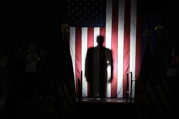 Republican presidential candidate former President Donald Trump, seen in silhouette, arrives to speak at a campaign rally on Wednesday, May 1, 2024, at the Waukesha County Expo Center in Waukesha, Wis. (AP Photo/Morry Gash)