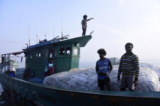 Fisherman work on a boat on March 3, 2023, in Kochi, Kerala state, India. (AP Photo/Satheesh AS)