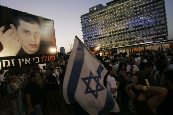 FILE - Israelis attend a demonstration calling for the release of abducted Israeli soldier Gilad Shalit, July 22, 2008, in Tel Aviv, Israel. Hamas militants seized Shalit in a cross-border raid on June 25, 2006, killing two other members of his tank crew. Hamas' 2006 seizure of Shalit consumed Israeli society for years — a national obsession that prompted Israel to heavily bombard the Gaza Strip and ultimately release over 1,000 Palestinian prisoners, many of whom had been convicted of deadly attacks on Israelis, in exchange for Shalit’s freedom. This time, Gaza’s Hamas rulers have abducted dozens of Israeli civilians and soldiers as part of a multipronged, shock attack. (AP Photo/Ariel Schalit, File)