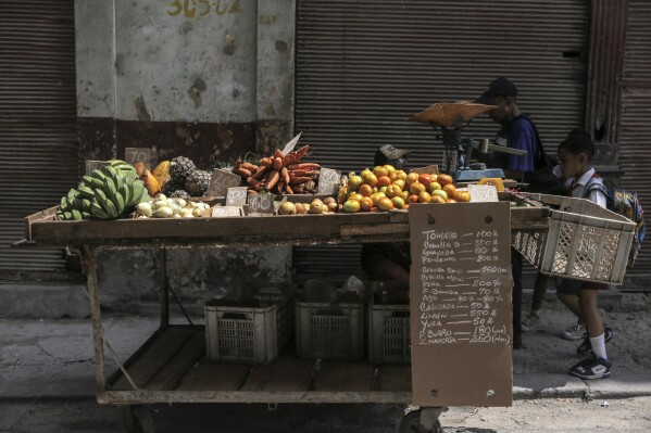 Produce is displayed on a cart in Havana, Cuba, Wednesday, March 13, 2024. Without a functioning market economy, Cuban agriculture has long measured itself by socialist production goals that it has rarely been able to meet. (AP Photo/Ariel Ley)